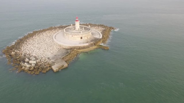 Bugio Lighthouse located on a very small island in the middle of the atlantic ocean. Shot by drone at Portugal, Lisbon
