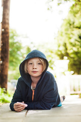 Portrait of boy lying on footpath © Cavan for Adobe