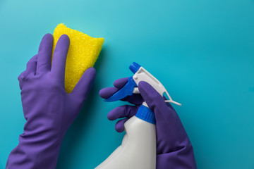 Female hands cleaning on blue background. Cleaning concept background. Flat lay, Top view.