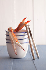 Close-up of crab claws in bowl stack on table against wall © Cavan for Adobe