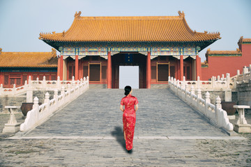 Asian young woman in old traditional Chinese dresses in the Forbidden city in Beijing, China.