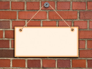 billboard on brick wall built with red brick. information for blank paper hanging on the wall