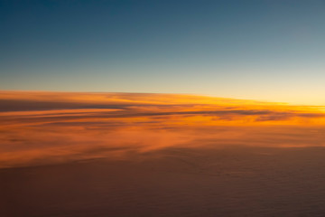 Fototapeta na wymiar beautiful aerial sunset flying over glowing orange clouds