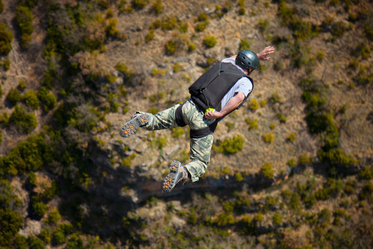 Rear view of man BASE jumping