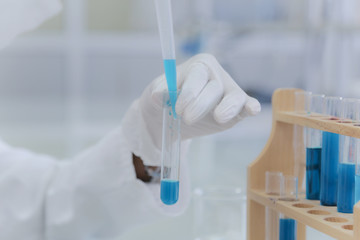 Young African Female Laboratory scientist working at lab with test tubes, test or research in clinical laboratory.Science, chemistry, biology, medicine and people concept.