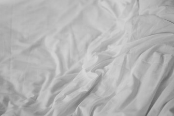 Empty crumpled bed in the bedroom after walk up.