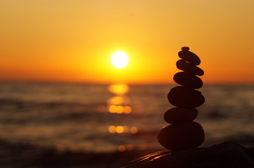 stone stacking sunset