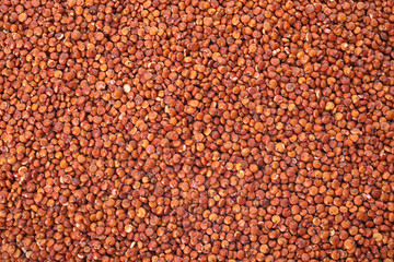 Raw red quinoa seeds as background, closeup