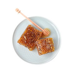 Plate with comb pieces and honey dipper isolated on white, top view