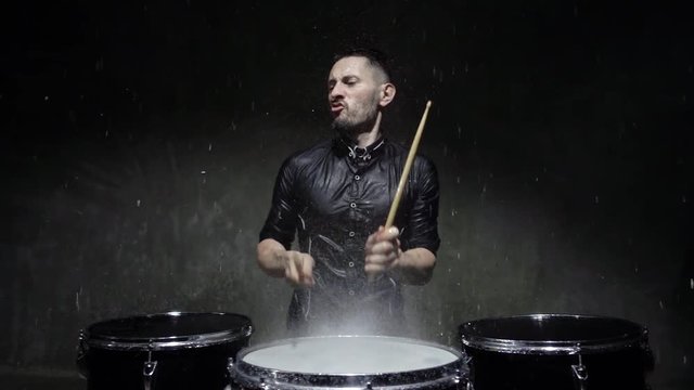 emotional drummer plays in water studio. 240fps slow motion