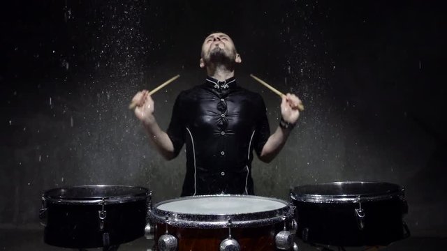 emotional drummer plays in water studio. 240fps slow motion