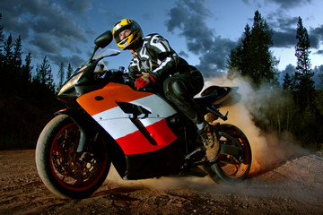 Man riding motorbike against sky at dusk © Cavan for Adobe