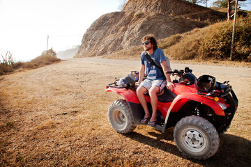 Man in sunglasses sitting on quadbike © Cavan for Adobe