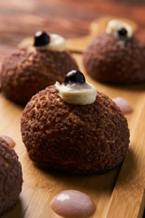 Brioche shu cake with cream chantilly, eclair. Chocolate profite