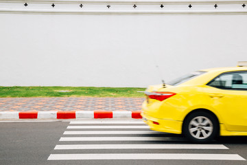 Yellow taxi on crosswalk road