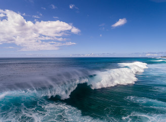 Aerial view of a big breaking wave