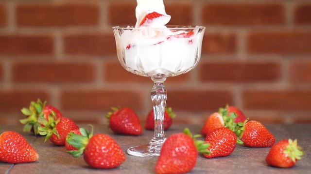 Mixing gourmet strawberry parfait, close up
