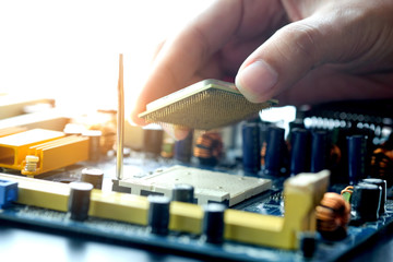 Hand of computer engineering brings computer cpu processor memory change components into socket processor for maintenance.Technology and development concept