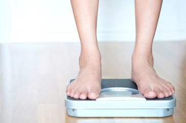 Legs of men standing on scales weight. Concept of health and weight loss.