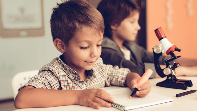 Sitting Boys Using Laptop and Microscope at Home. - Powered by Adobe