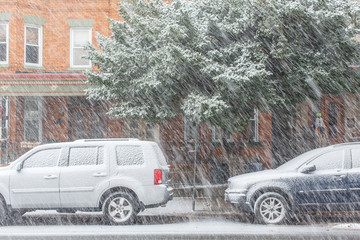 Residential neighborhood during snow thunder, snow fall, car covered snow