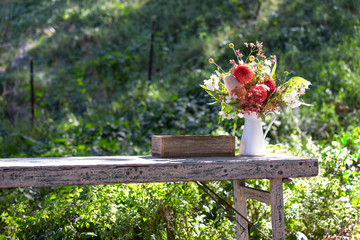 Fototapeta na wymiar Wedding flower bouquet on a wooden table in a white vase. 