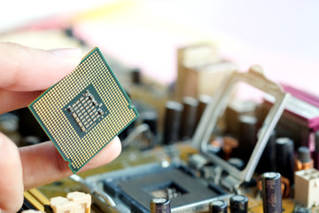 Hand of computer engineering brings computer cpu processor memory change components into socket...
