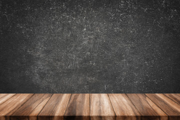 wood table with grunge concrete wall.