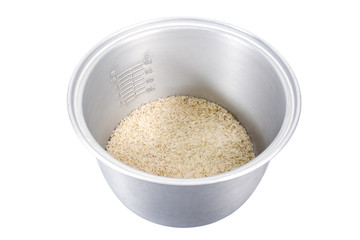 Rice in electric rice cooker pot with scales isolated on white background. Rice with scales in electric rice cooker pot isolated.