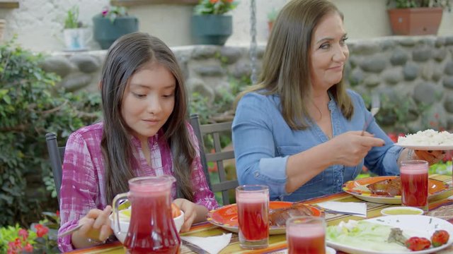 Hispanic family eating traditional meal together