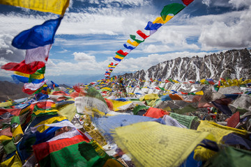 Colourful Buddhist religious stupas and prayer flags at Khardung La pass, the highest (5,359 m, 17,582 ft) motorable pass on the world. Ladakh, Jammu and Kashmir, India