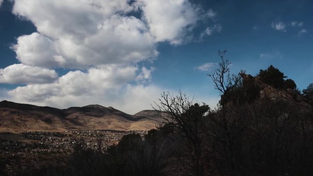 clouds and shadows moving across Ken Caryl valley, littleton, colorado with outcrop of Dakota Hogback in view
