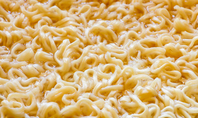 Instant noodles cooking ,close up boil noodles in pan for backgrounds or textures, junk food concept.