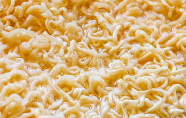 Instant noodles cooking ,close up boil noodles in pan for backgrounds or textures, junk food concept.