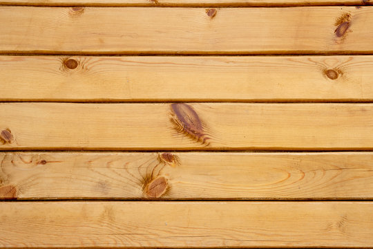 Wood texture background. wooden panel with horizontal gaps, planks and chinks. Background with wooden beams, timber. pine board. Wooden beams. Sawn timber from coniferous wood.