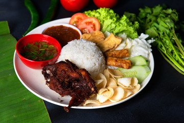 nasi lemak kukus with quail meat top view, malaysian local food