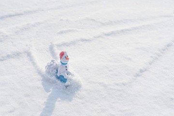 Fototapeta na wymiar Beautiful snowman on natural snowdrift.