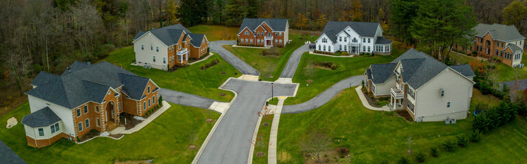 Aerial panorama of upper middle class single family homes neighborhood street American real estate...