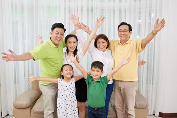 Joyful big Vietnamese family looking at camera