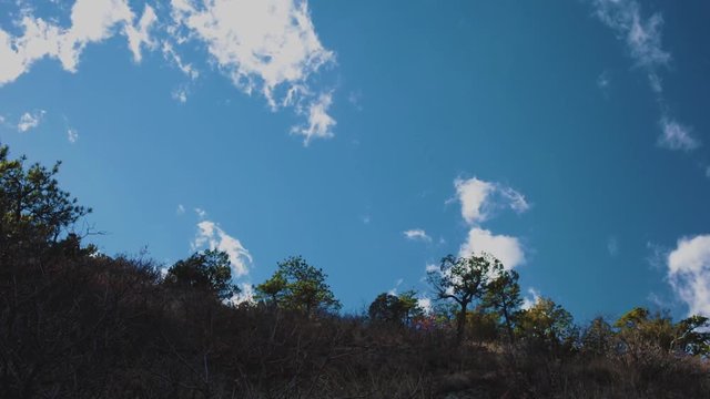 white clouds moving across Lyons Hogback