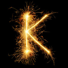 number and english alphabets from golden sparkler on black background