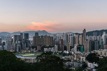 Fototapeta na wymiar Sunset over Happy Valley district, famous for its horse racecourse in Hong Kong island, Hong Kong SAR in China