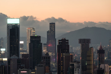 Sunset Hong Kong business district skyline around Wanchai from above Happy valley in Hong Kong island with the peak of kowloon in the background