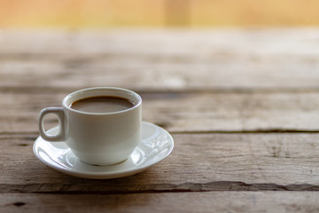 cup of coffee on a wooden table in the morning