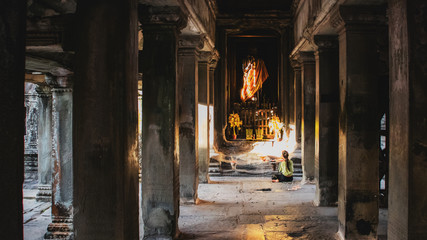 Asian woman prays in the temple That pray for faith in Buddhism Angkor Wat .