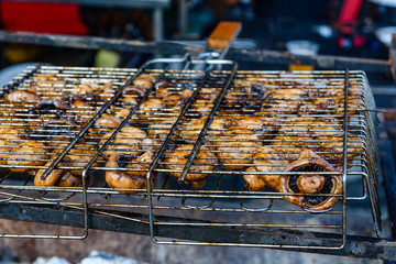 Champignons preparing in a barbecue grill on picnic