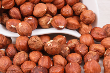 Hazelnuts in white bowl, healthy nutrition and lifestyle concept