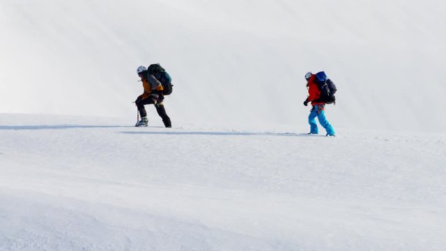Aerial view of mountaineers on a snow covered mountain in Alaska America