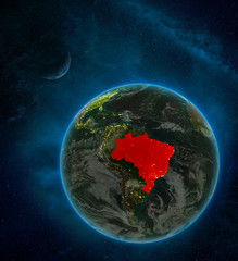 Brazil from space on Earth at night surrounded by space with Moon and Milky Way. Detailed planet with city lights and clouds.