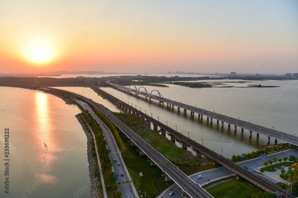 Poster jiujiang cityscape of lake and bridge in sunset